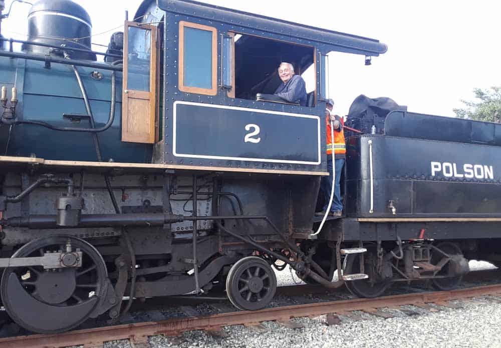 Skip Lichter, owner of Polson Lumber #2, sits in the cab.