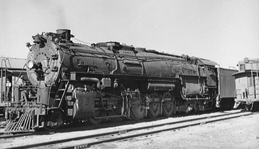 An AT&SF Texas type leads a freight train in New Mexico.